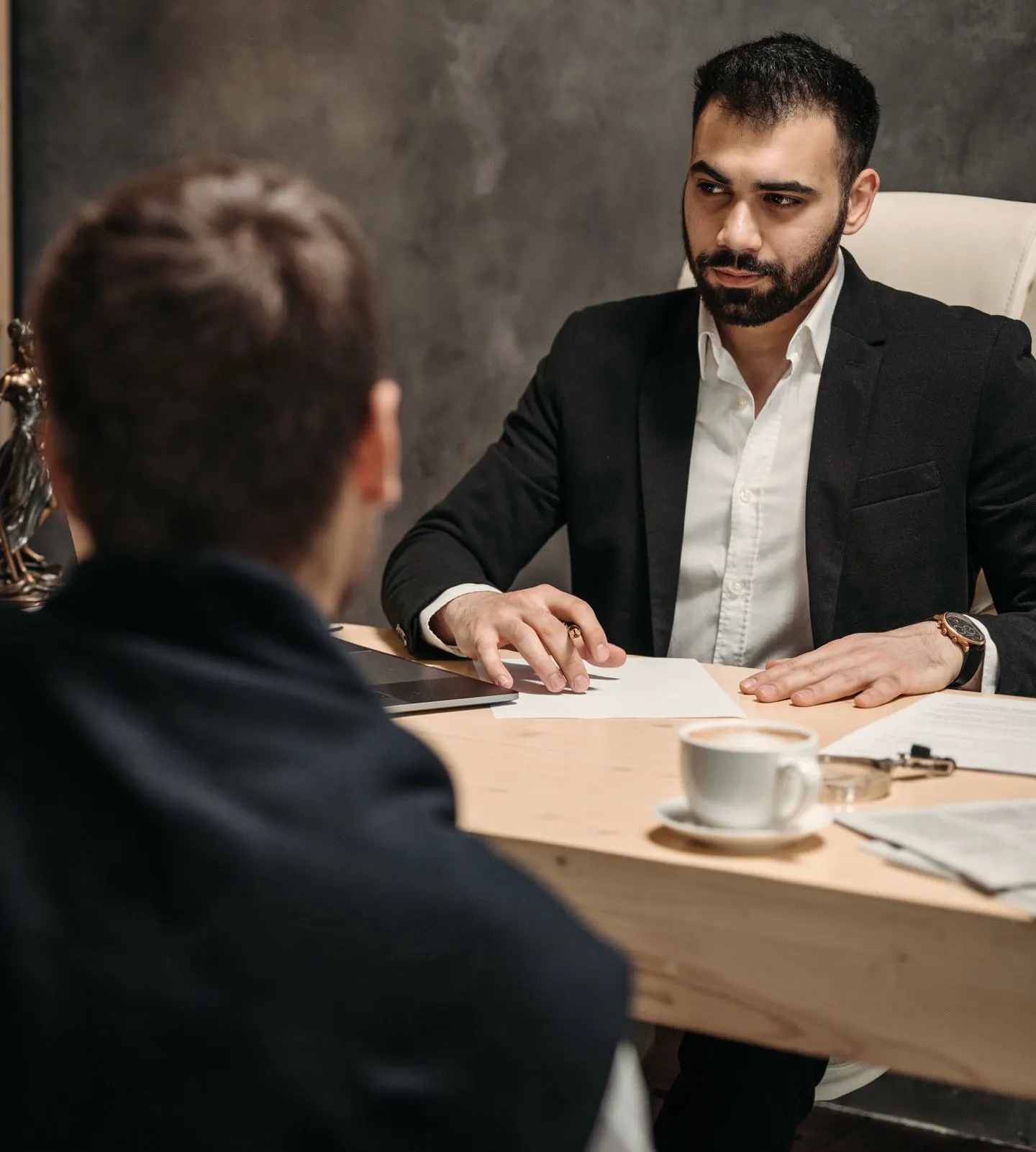 A lawyer and a client talking across a desk