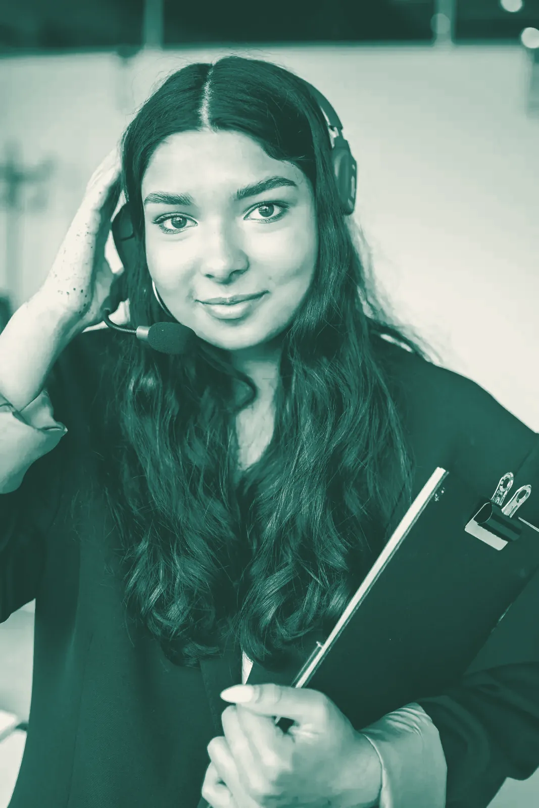 An agent with a headset holding a clipboard