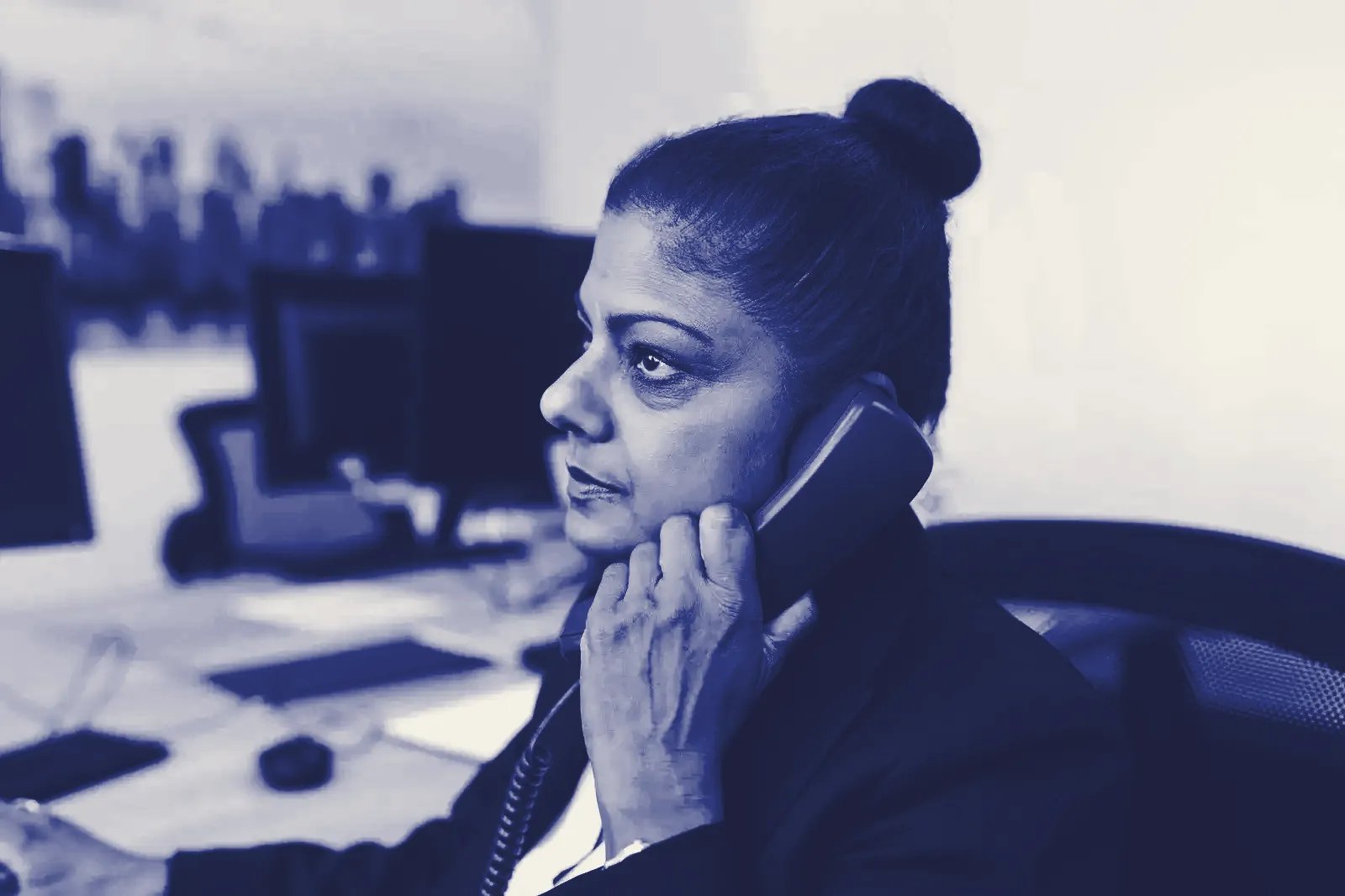 A woman at her desk on the phone