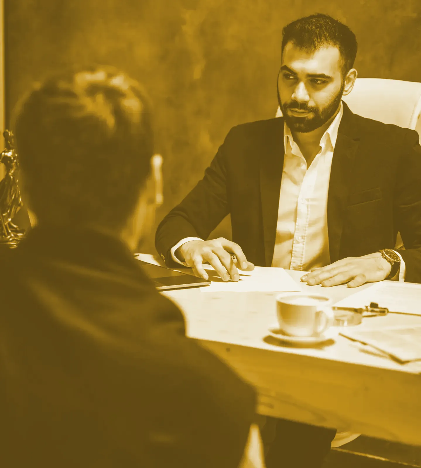 Two people across a desk in a meeting