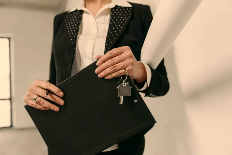 A hand passing a set of keys
